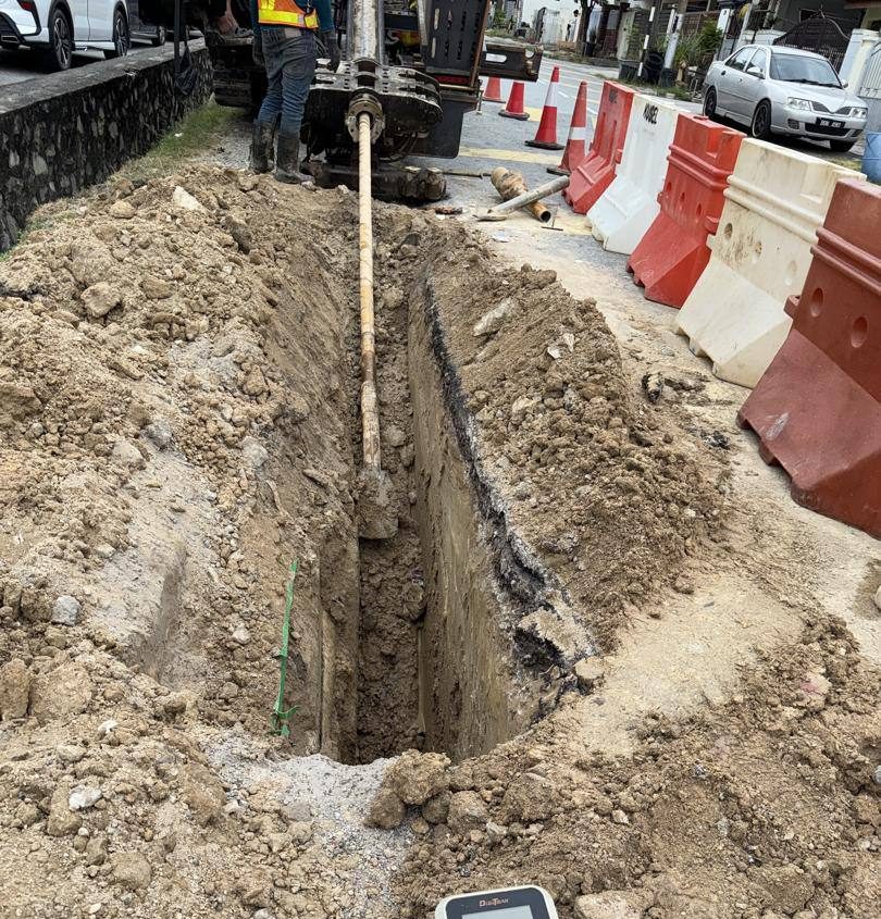 Deep trench excavation for underground cable laying along a residential road